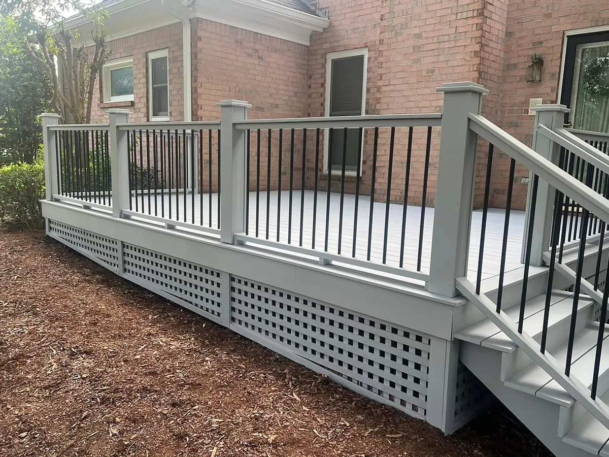 grey deck attached to a brick house