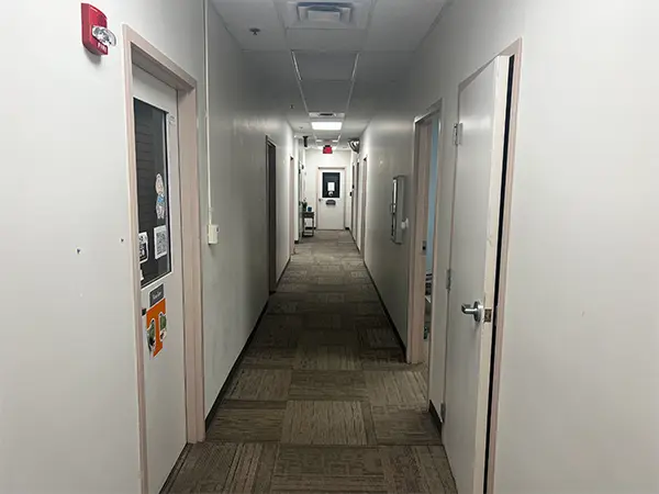 hallway with white walls and doors