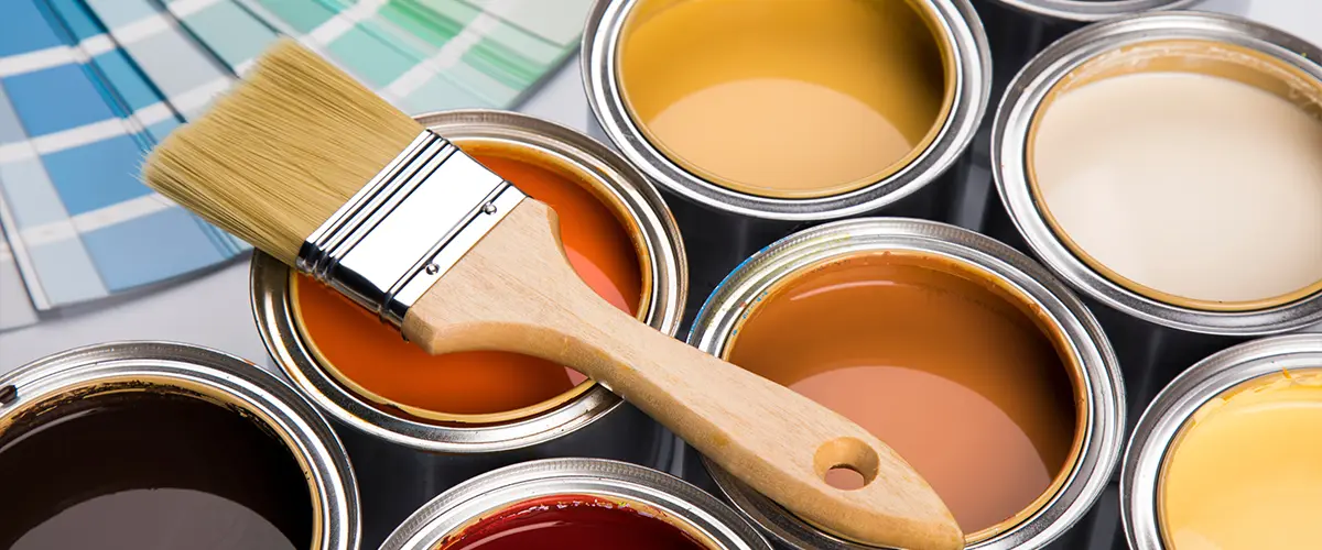 Colorful paint cans with paintbrush. Satin vs. Semi-Gloss Paint: Making the Right Choice for Your Home