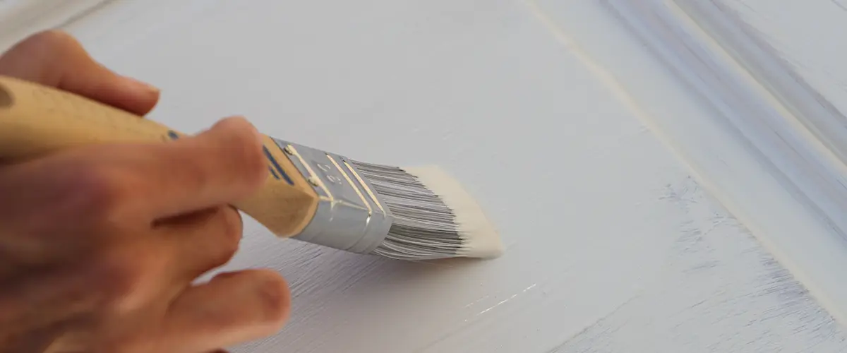 a brown kitchen cabinet is painted with white chalk paint