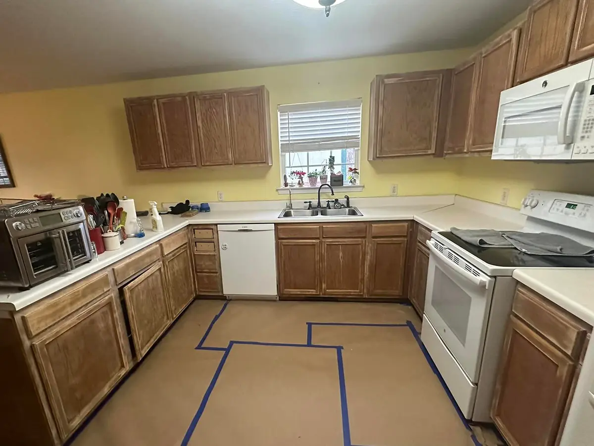 kitchen with brown cabinets with worn-out paint