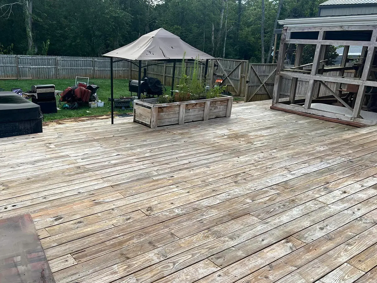 a wooden deck with a gazebo and a fence
