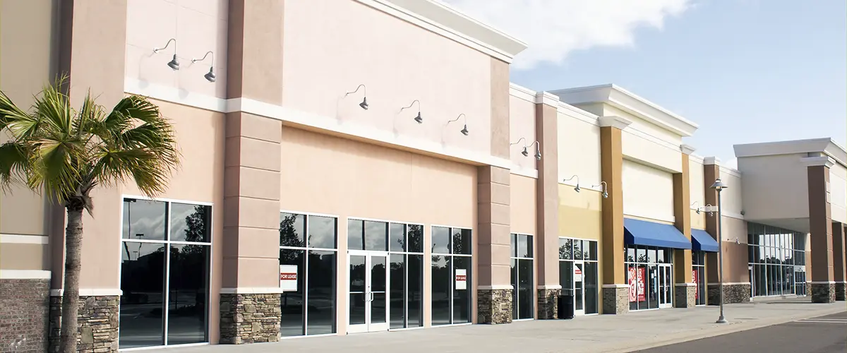 Strip mall with freshly painted exterior walls in neutral tones