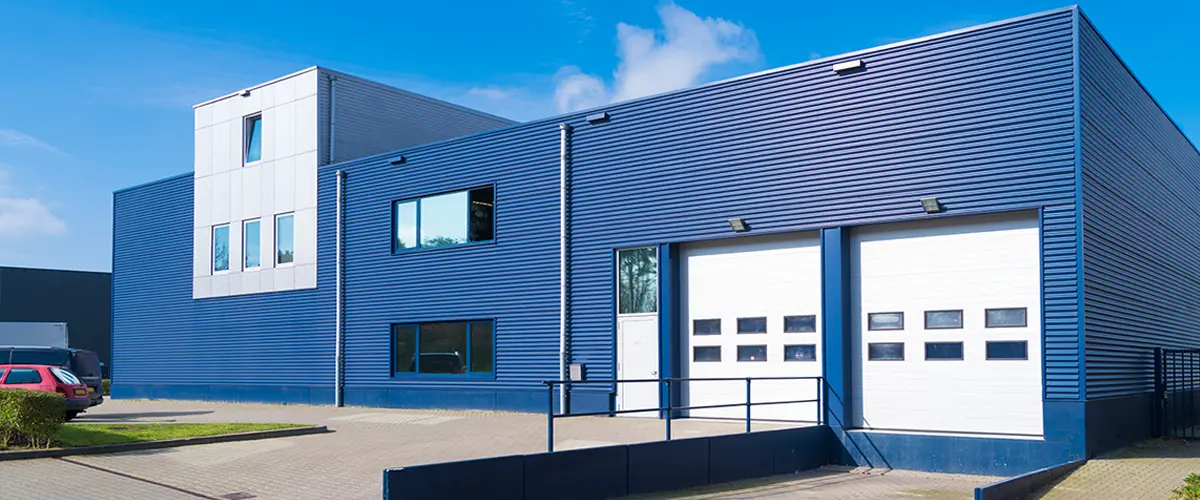 Modern blue commercial building with garage doors