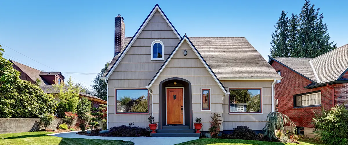 Small gable roof home with fresh tan exterior paint