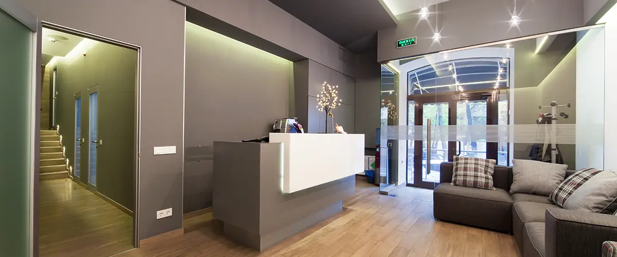 Interior of modern commercial space with gray walls and reception desk