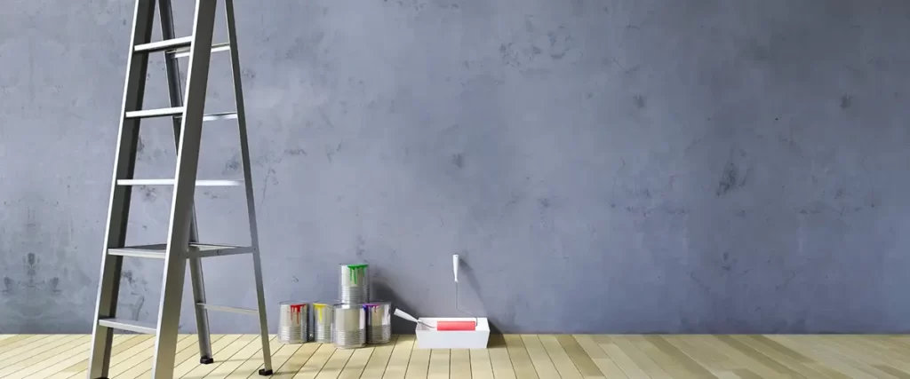 Ladder and paint cans prepared for interior wall painting