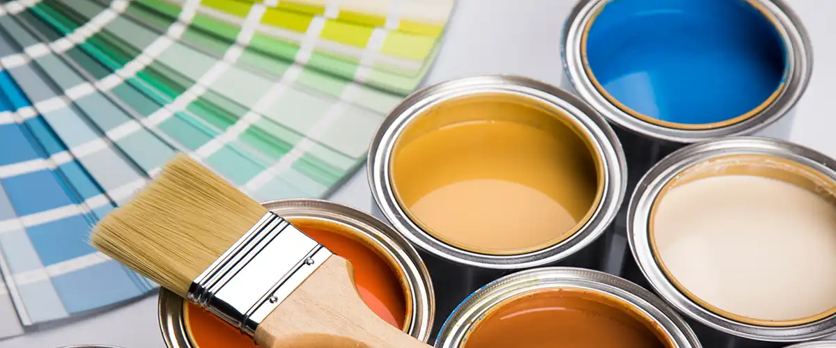 Open paint cans with brush and color palette samples