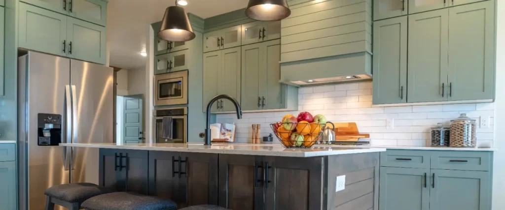 A kitchen featuring blue cabinets and a single bar stool