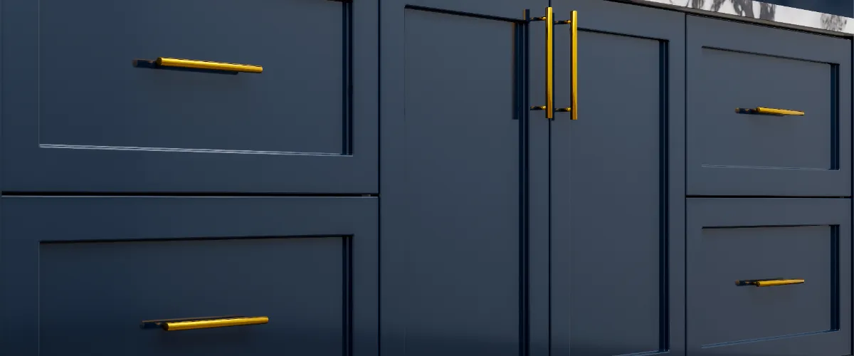 a close-up of navy blue kitchen cabinets with gold-toned handles