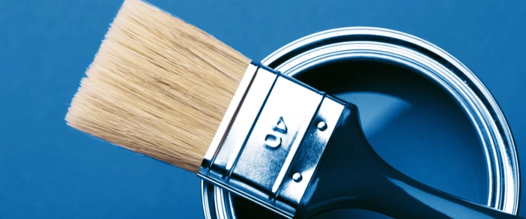 Image of a paint brush on a blue paint can