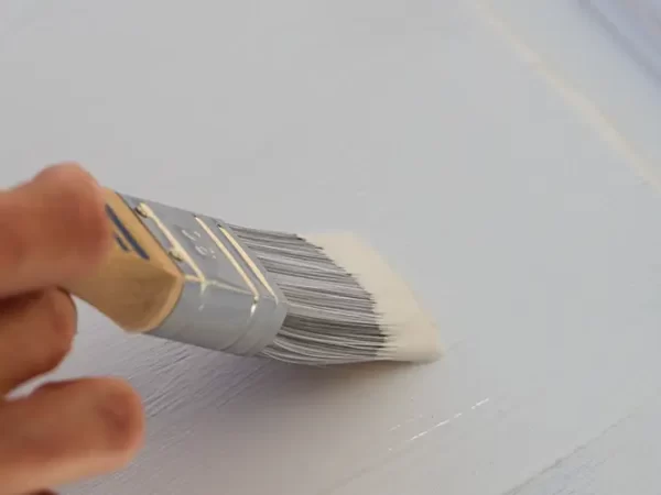 a brown kitchen cabinet is painted with white chalk paint