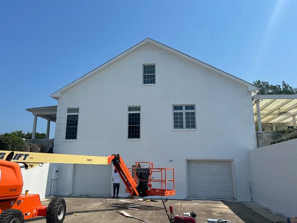 men painting house white